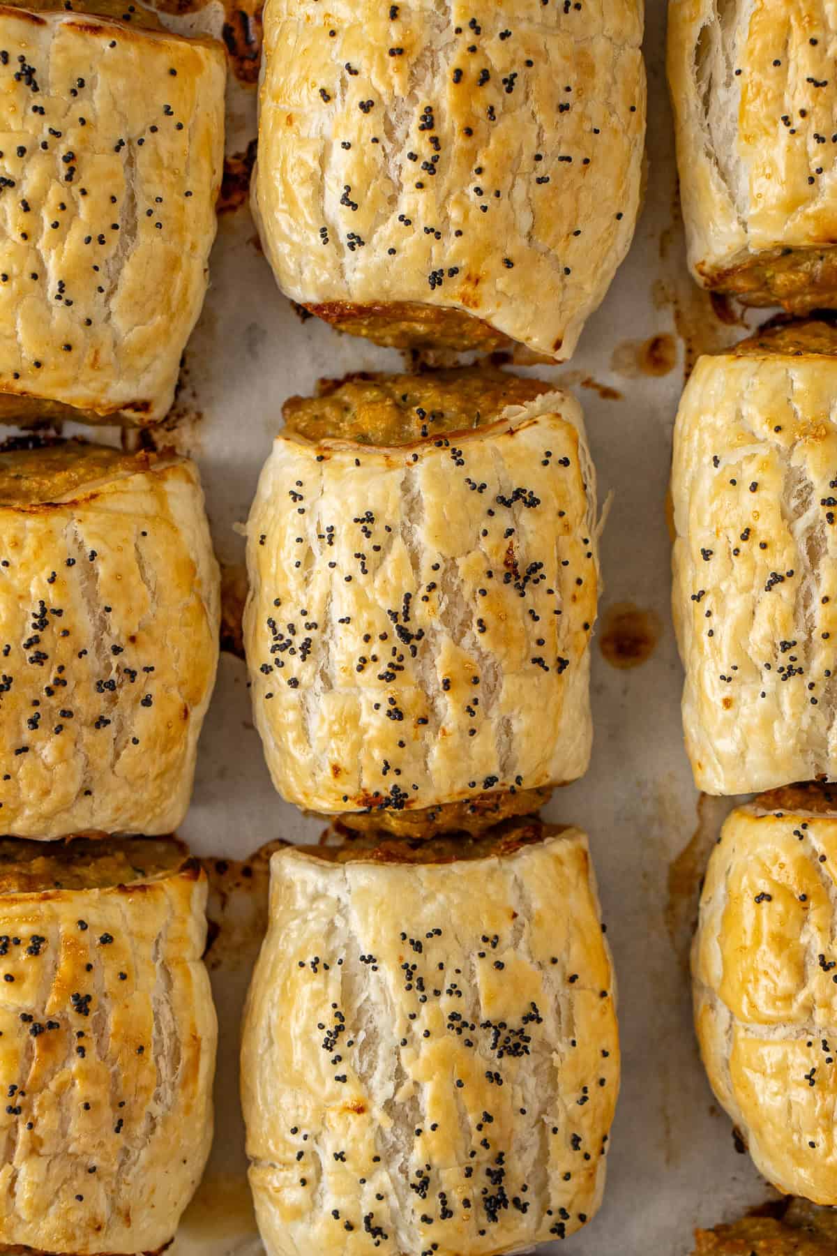 Close up of the baked sausage rolls on a tray.