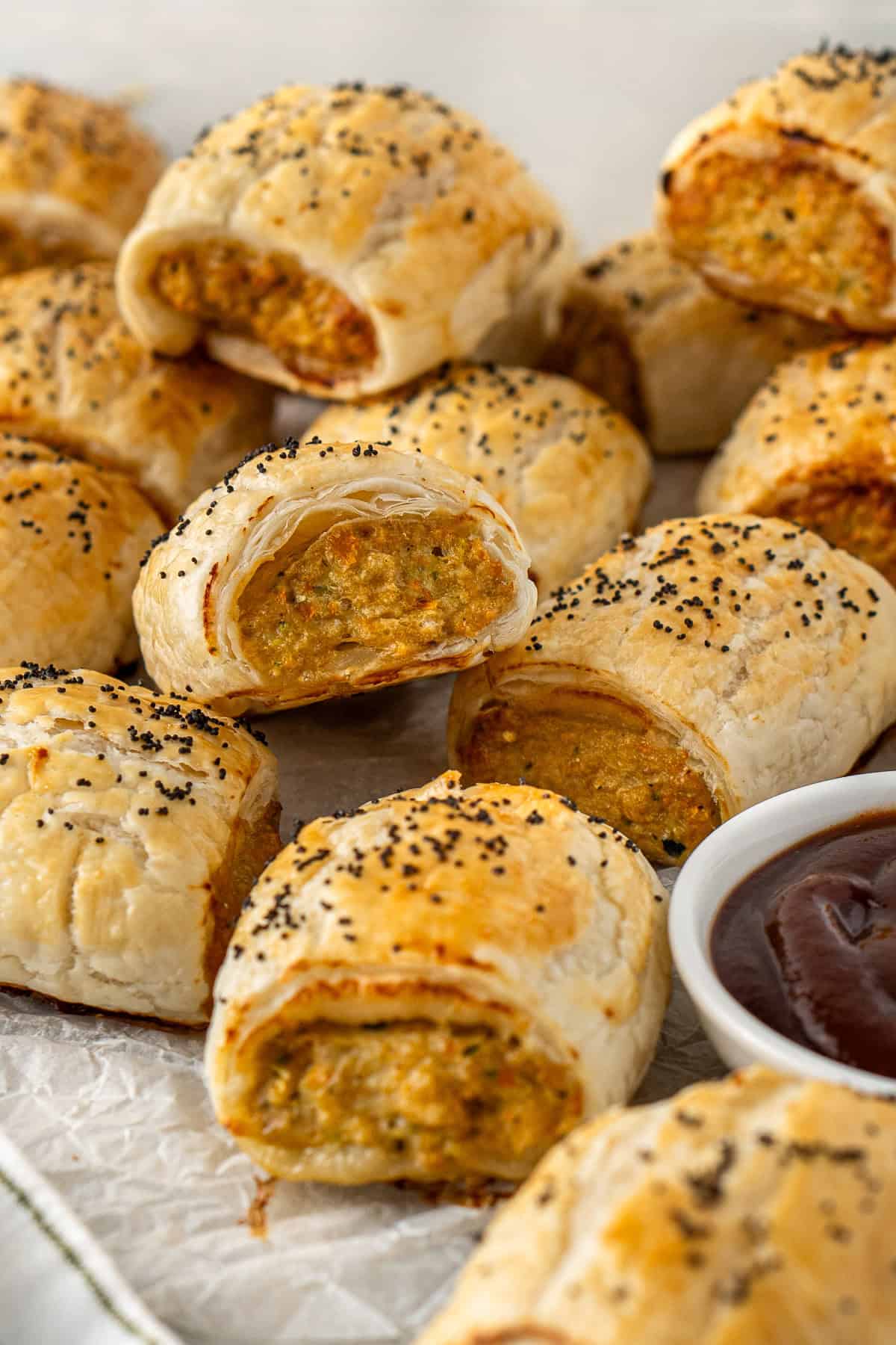 A plate of chicken sausage rolls with sauce.