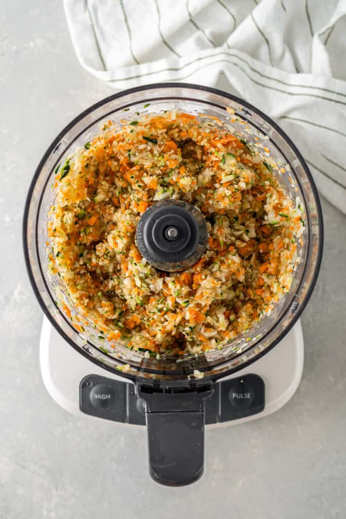 The chopped vegetables for the filling in a food processor. 
