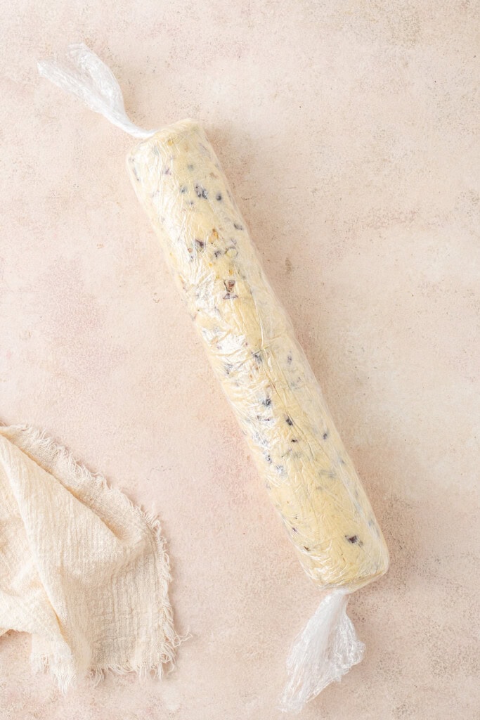 The rolled up cookie dough in plastic wrap.