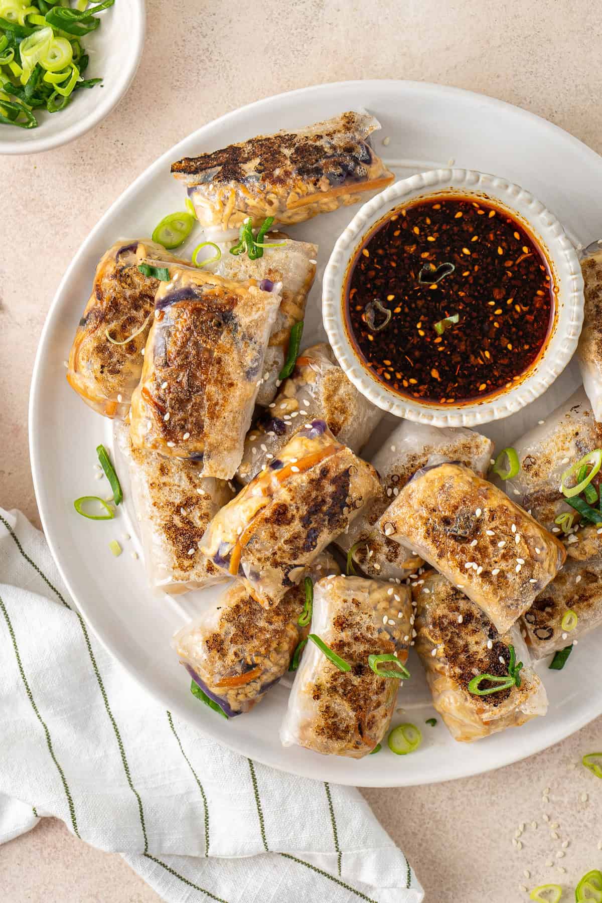 The crispy rice paper dumplings on a plate with dipping sauce.