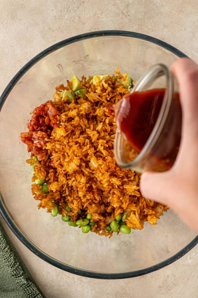 Adding the dressing to the crispy rice salad.