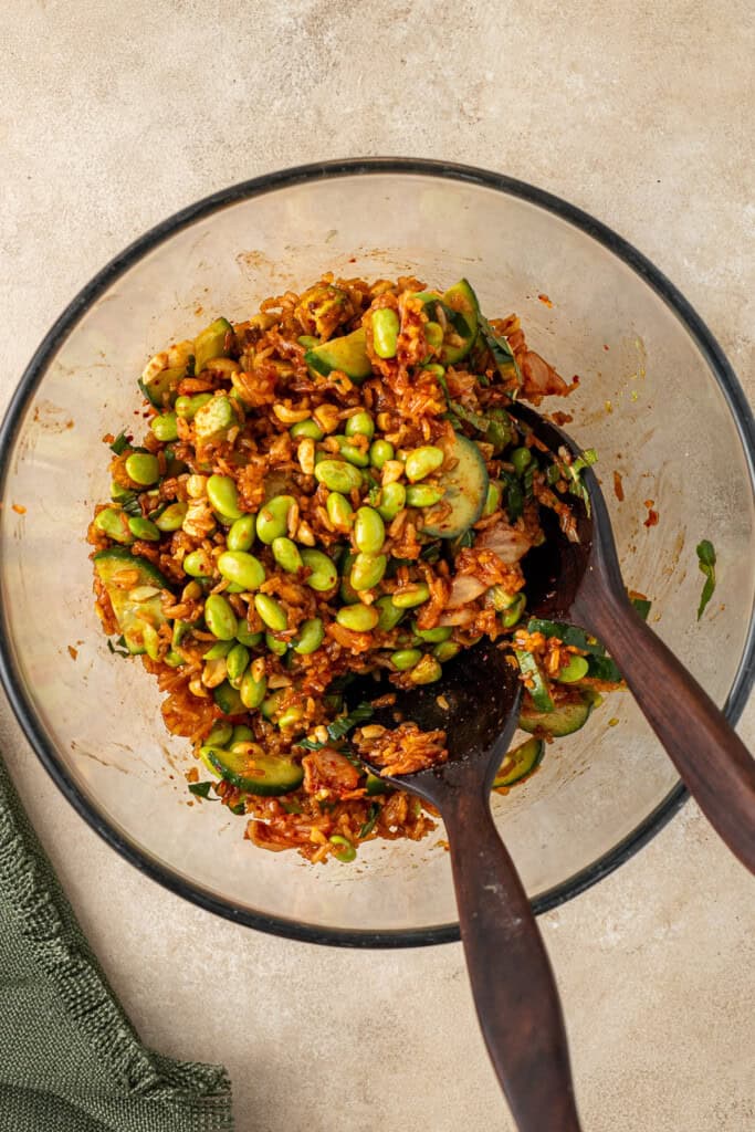 Tossing the salad in the mixing bowl.
