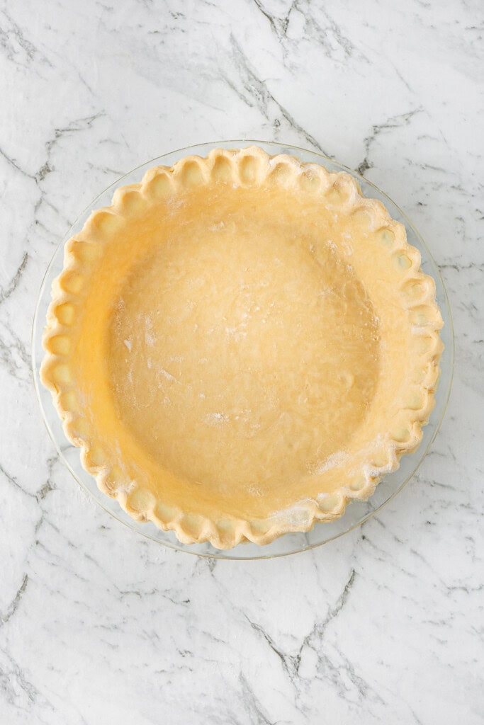 The dough pressed and fluted in the pie dish.
