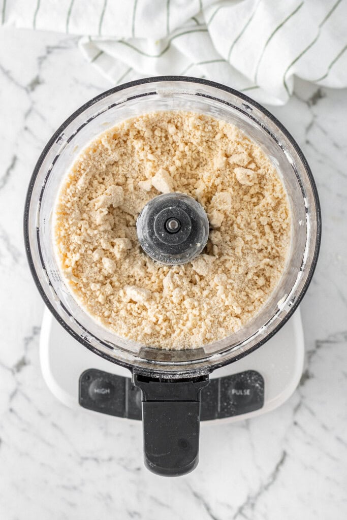 The mixture in the food processor resembling wet sand.