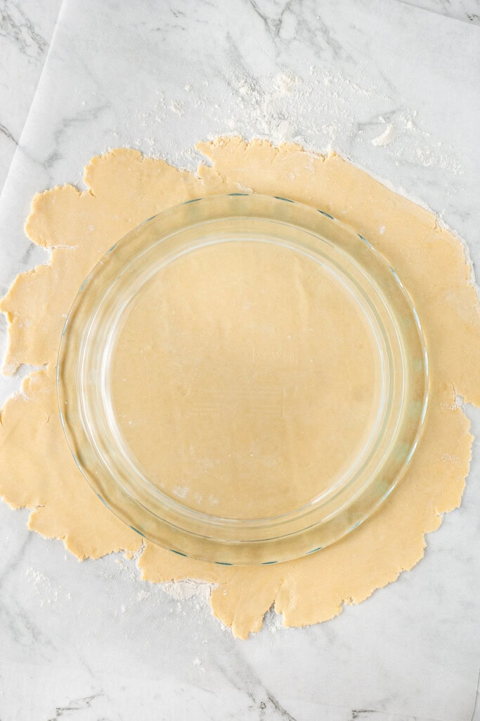 Rolling out the pie dough to the right size.