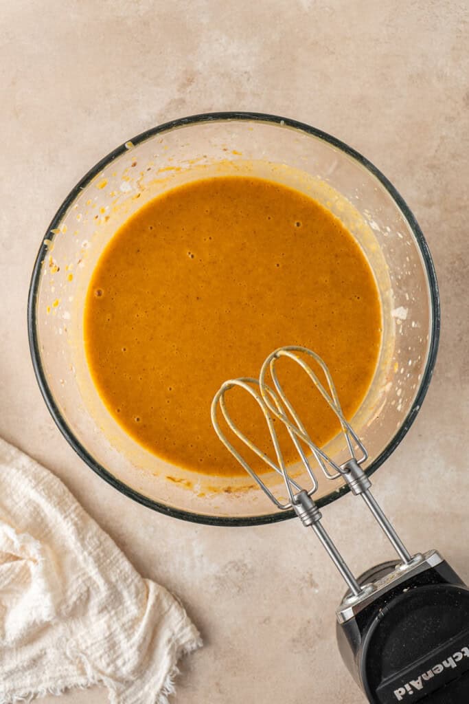 Mixing the pie filling with electric beaters. 