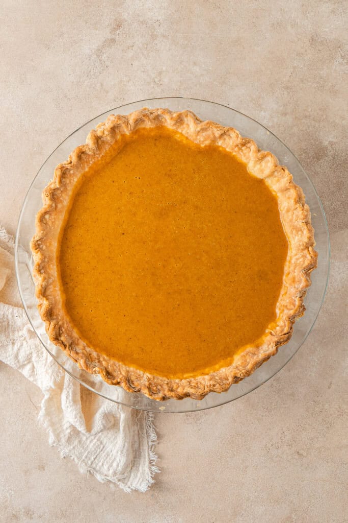 Adding the filling to the pie crust.
