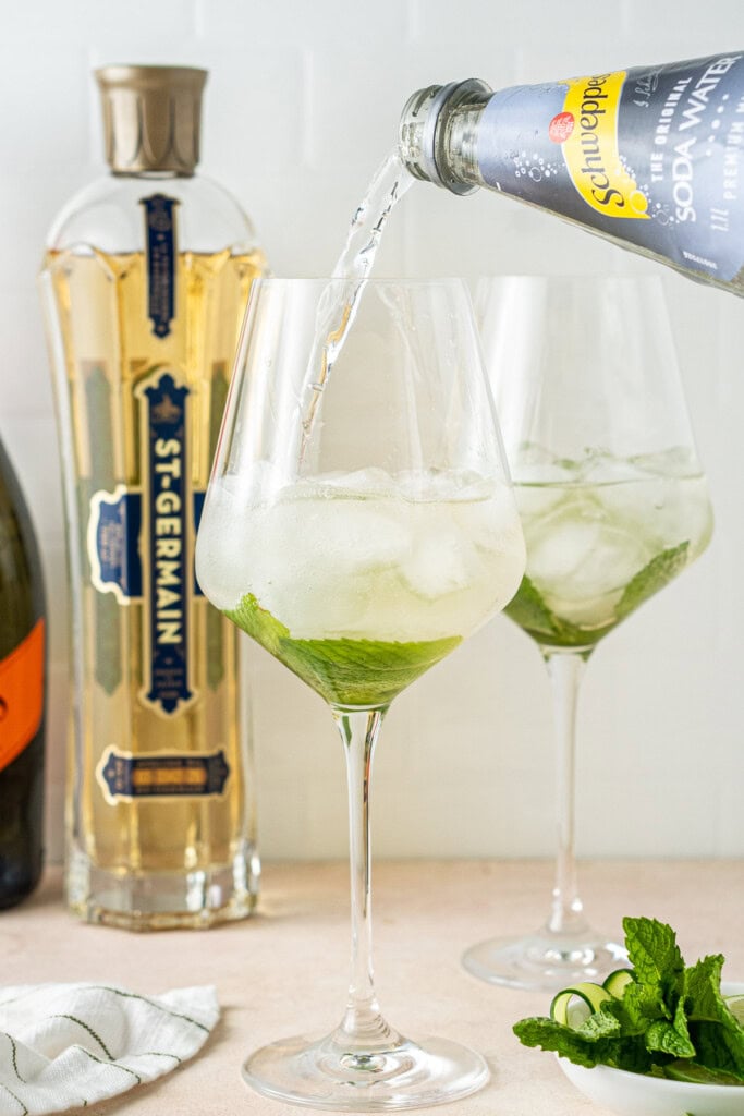 Pouring soda water into the glass.