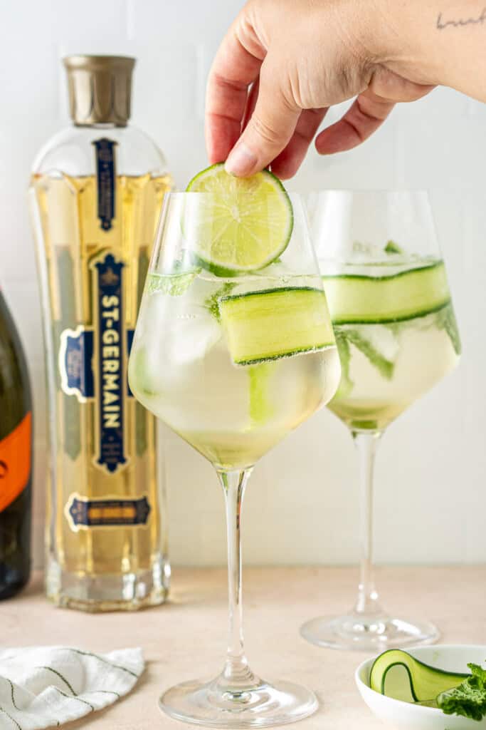 Adding garnishes to the hugo spritz.