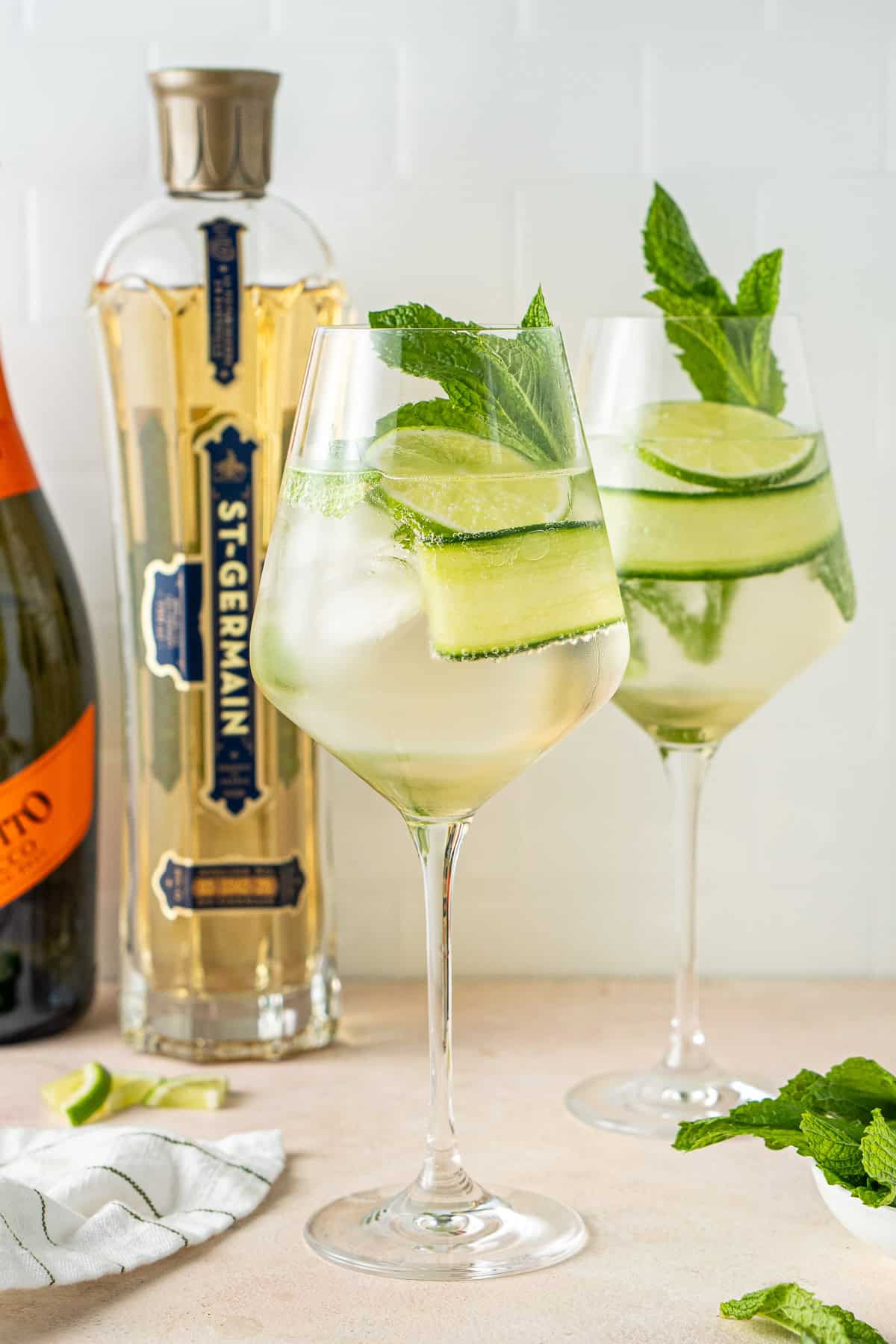 Two elderflower spritz cocktails in glasses.