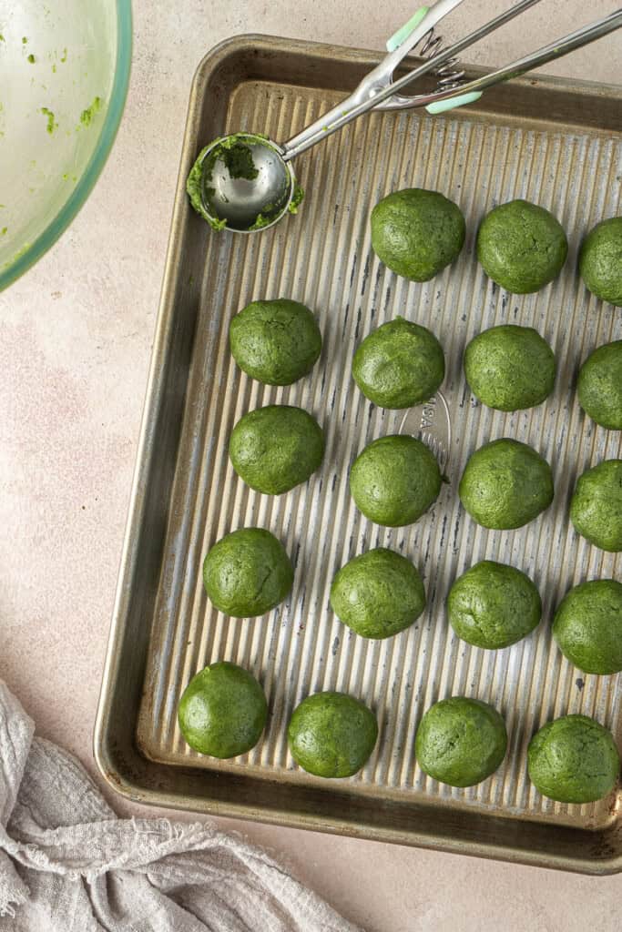 Rolling out balls of cookie dough.