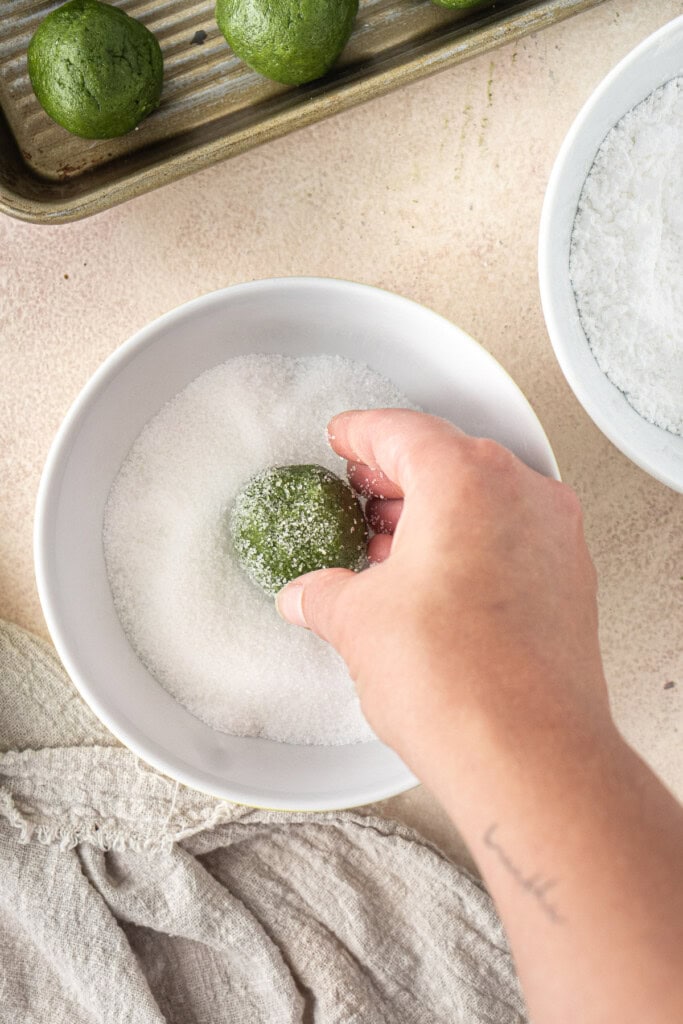 Rolling the balls in the white sugar.