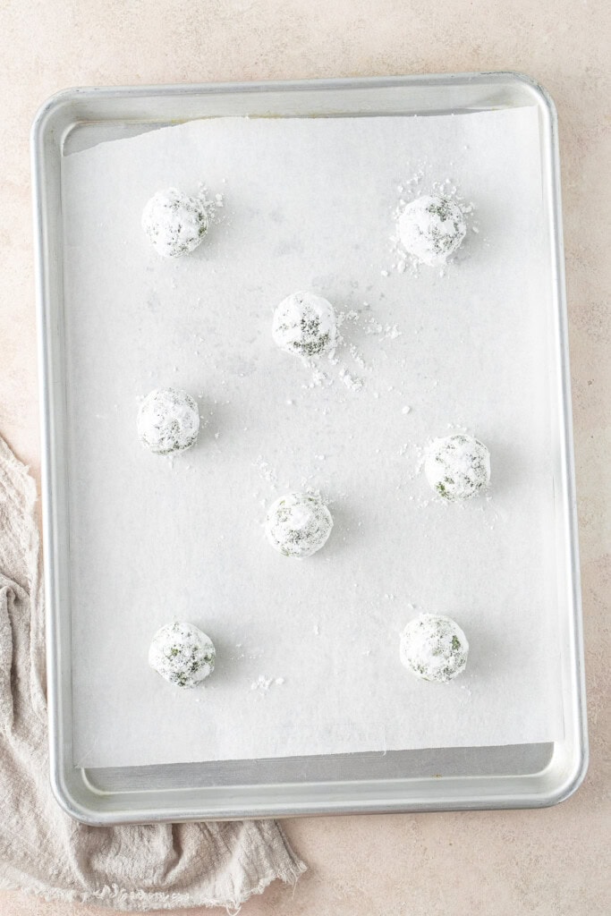 The coated cookie dough balls on the baking tray.