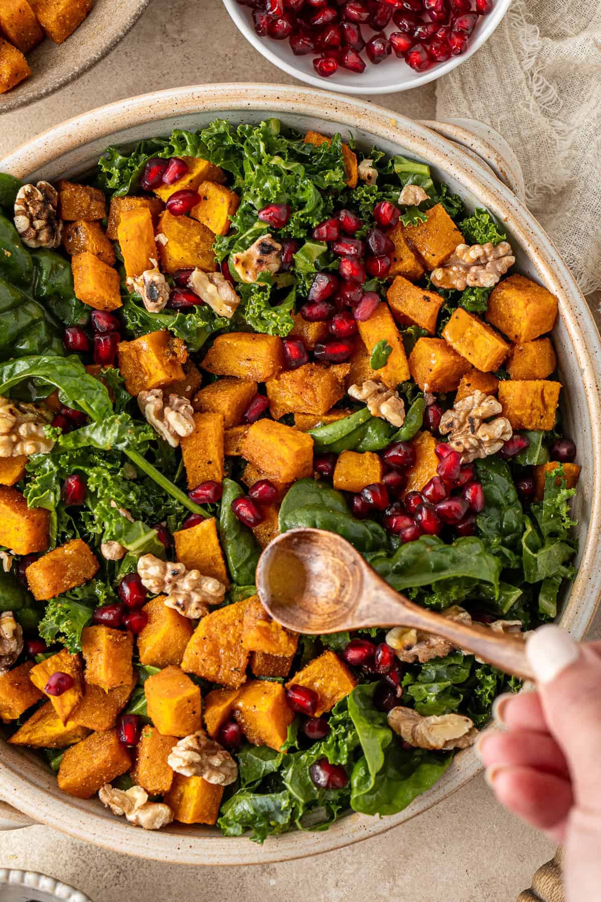 Spooning the dressing over the salad.