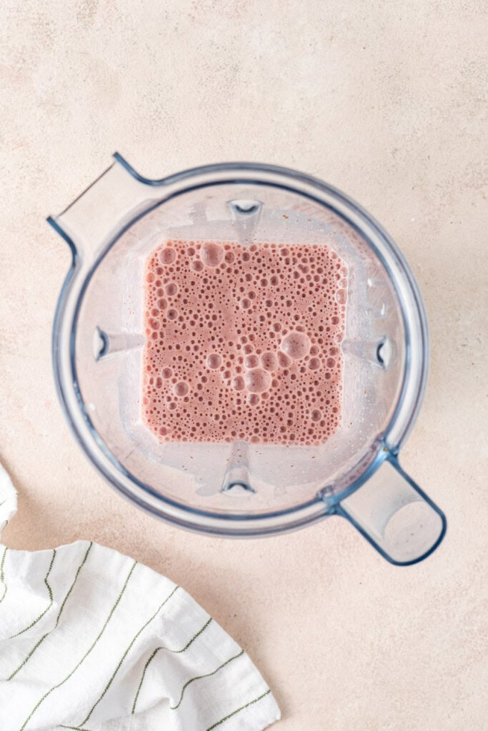 The smoothie blended in a blender.