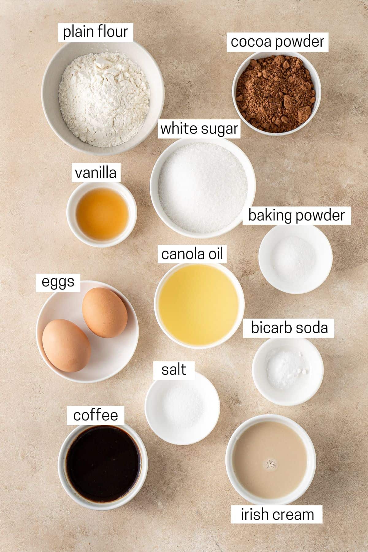 All ingredients needed to make Irish cream cupcakes laid out in small bowls.