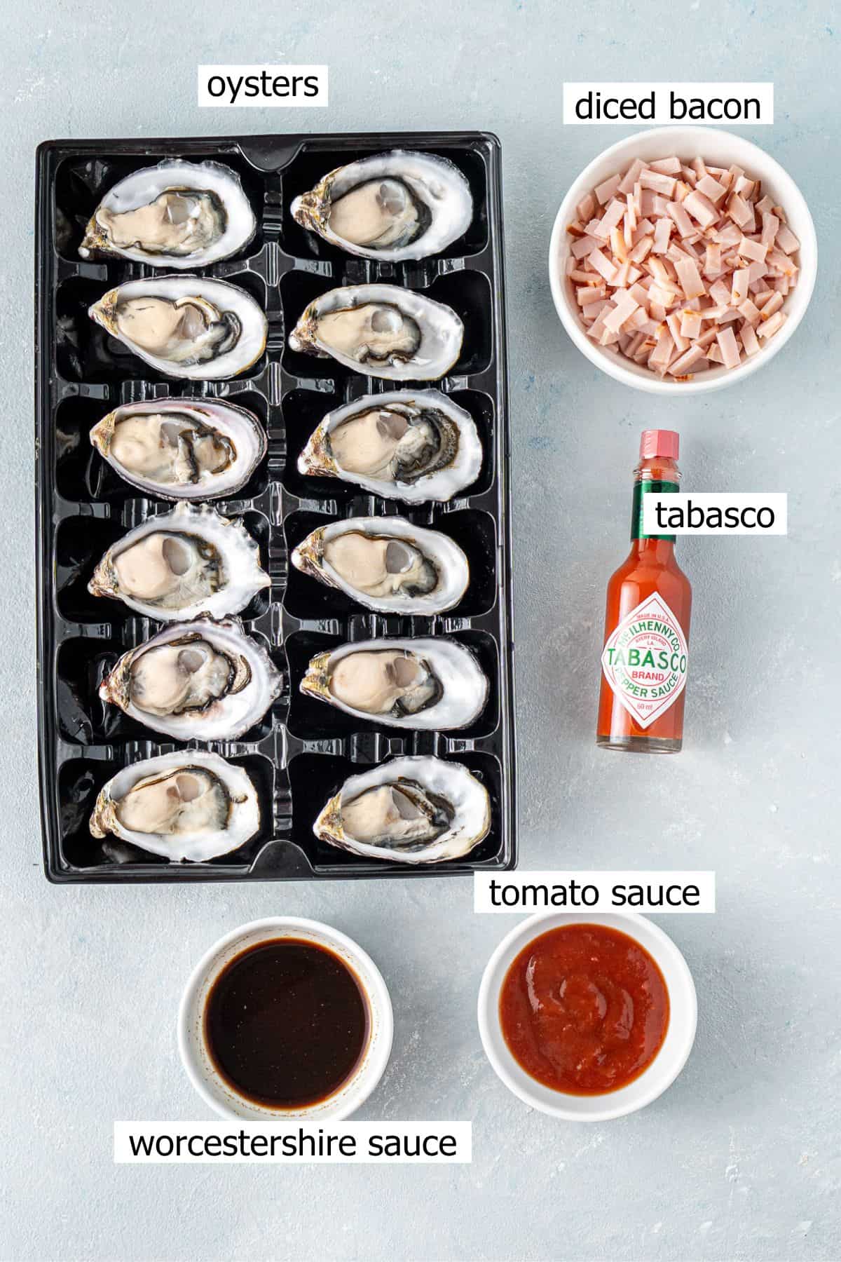 All ingredients needed to make oysters kilpatrick laid out in bowls.