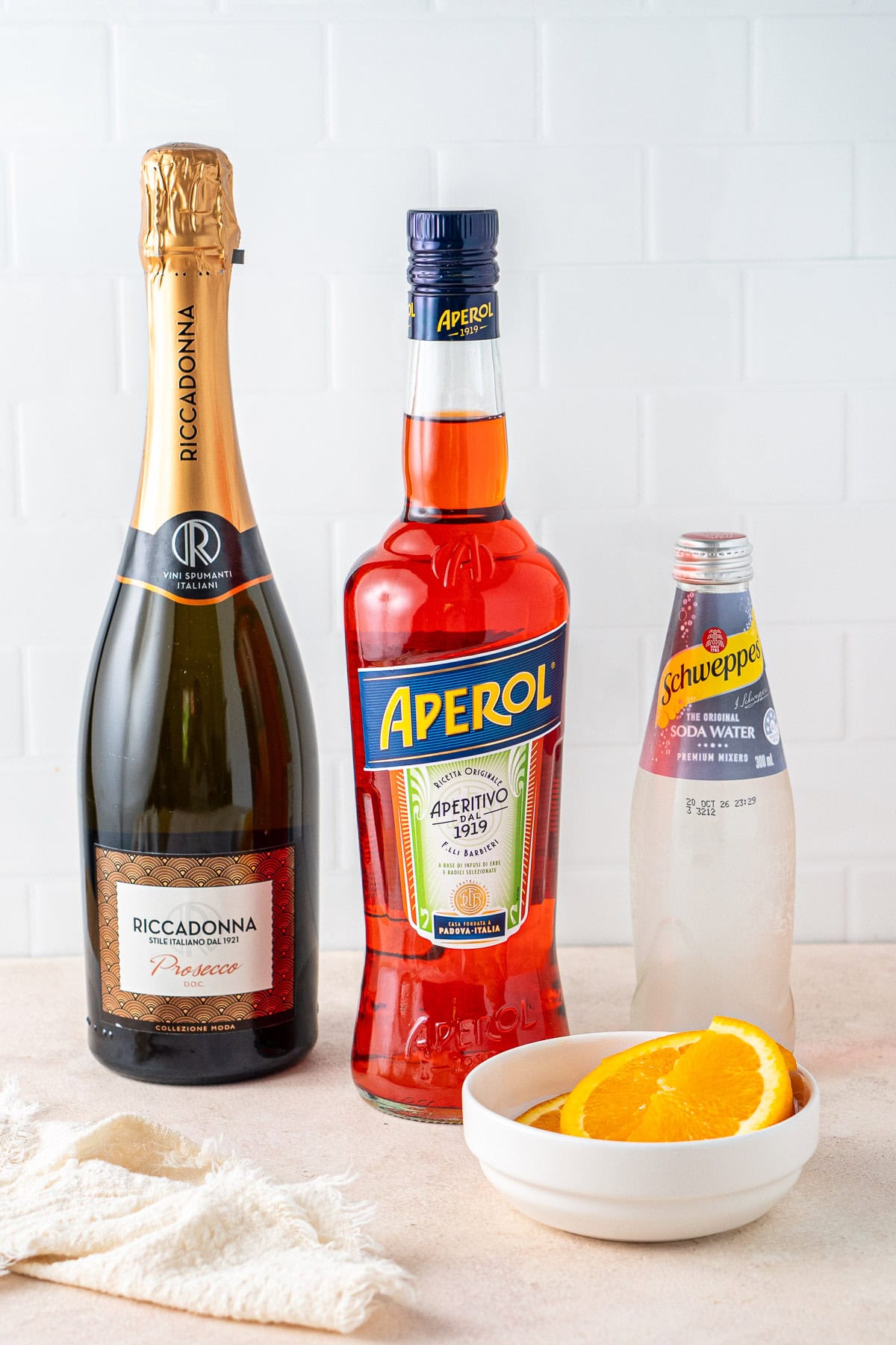 All ingredients needed to make an aperol spritz.