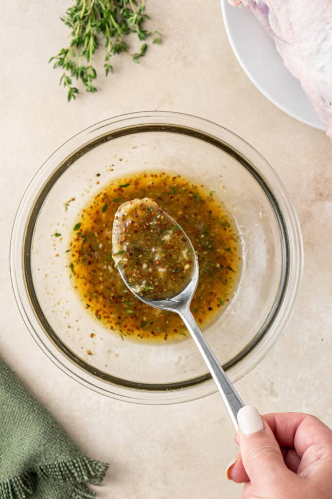 Mixing the glaze in a bowl with a spoon.