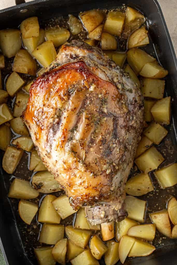The roast lamb and potatoes in the baking tray.
