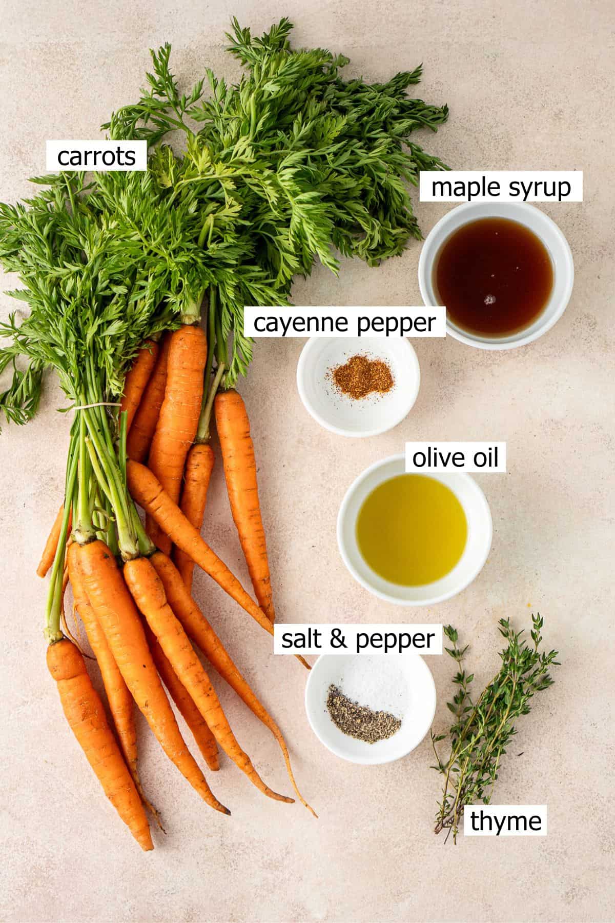 All ingredients needed to make maple glazed carrots laid out in bowls.