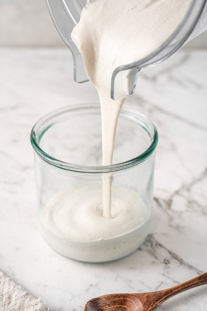 Pouring the cream into a jar.