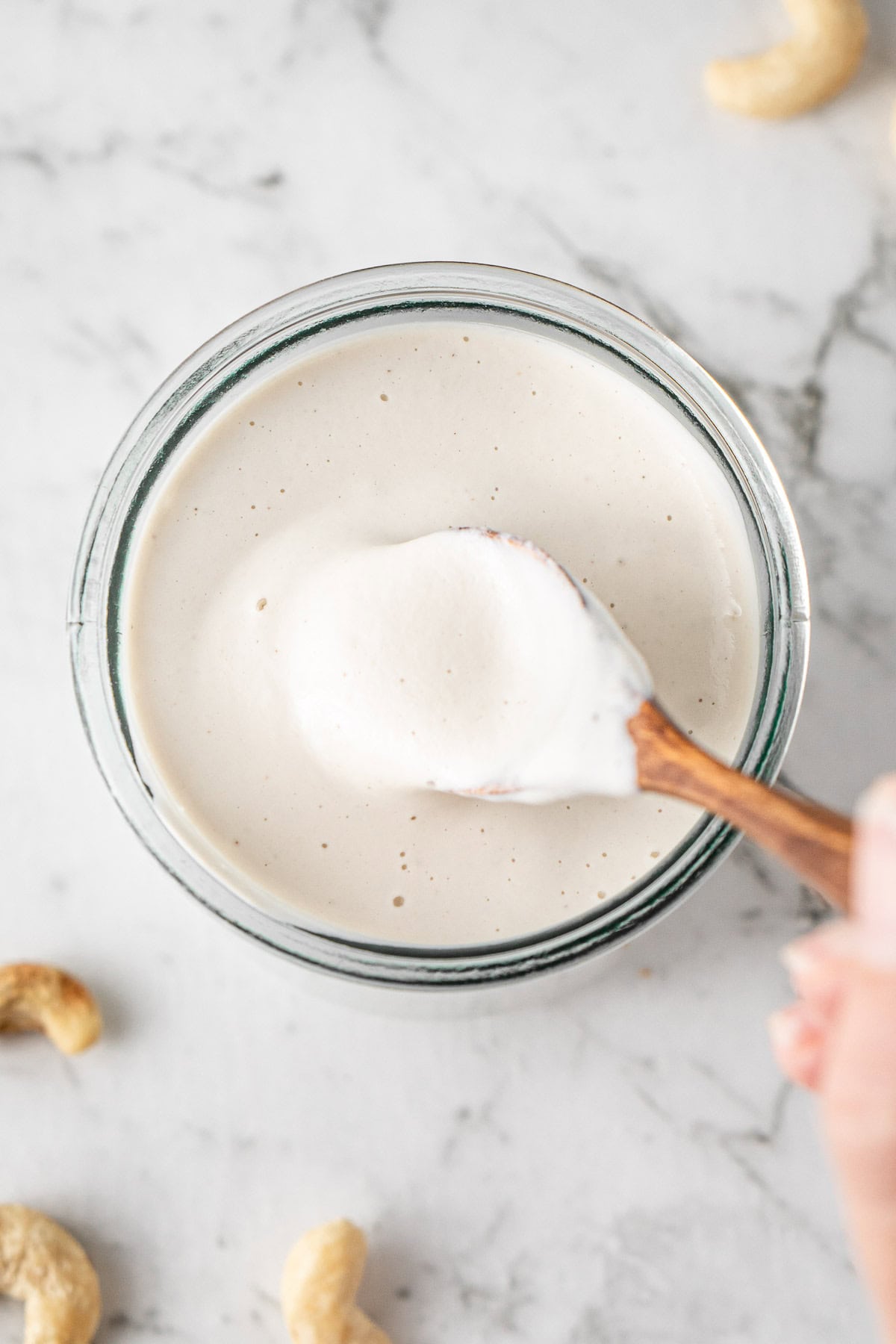 A spoon in the jar of dairy free cream.
