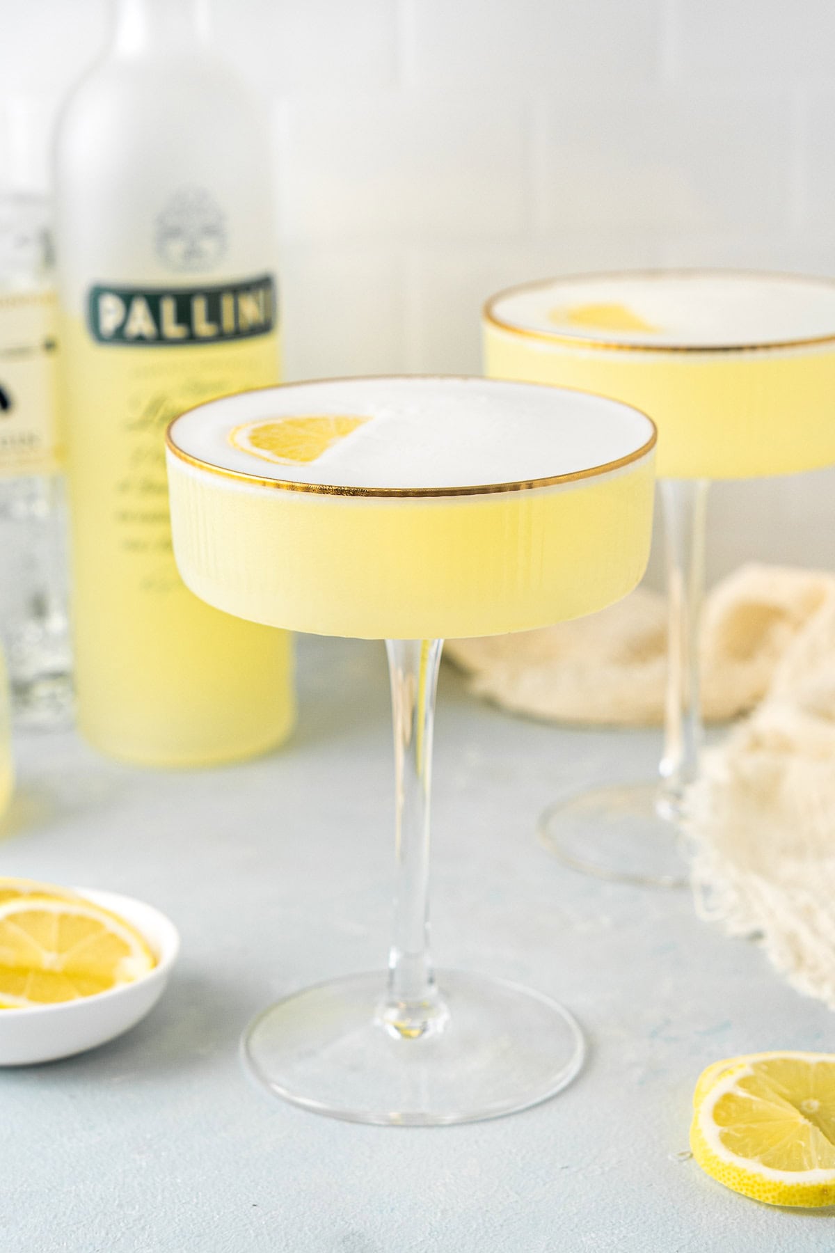Limoncello sour cocktails in a coupe glass.