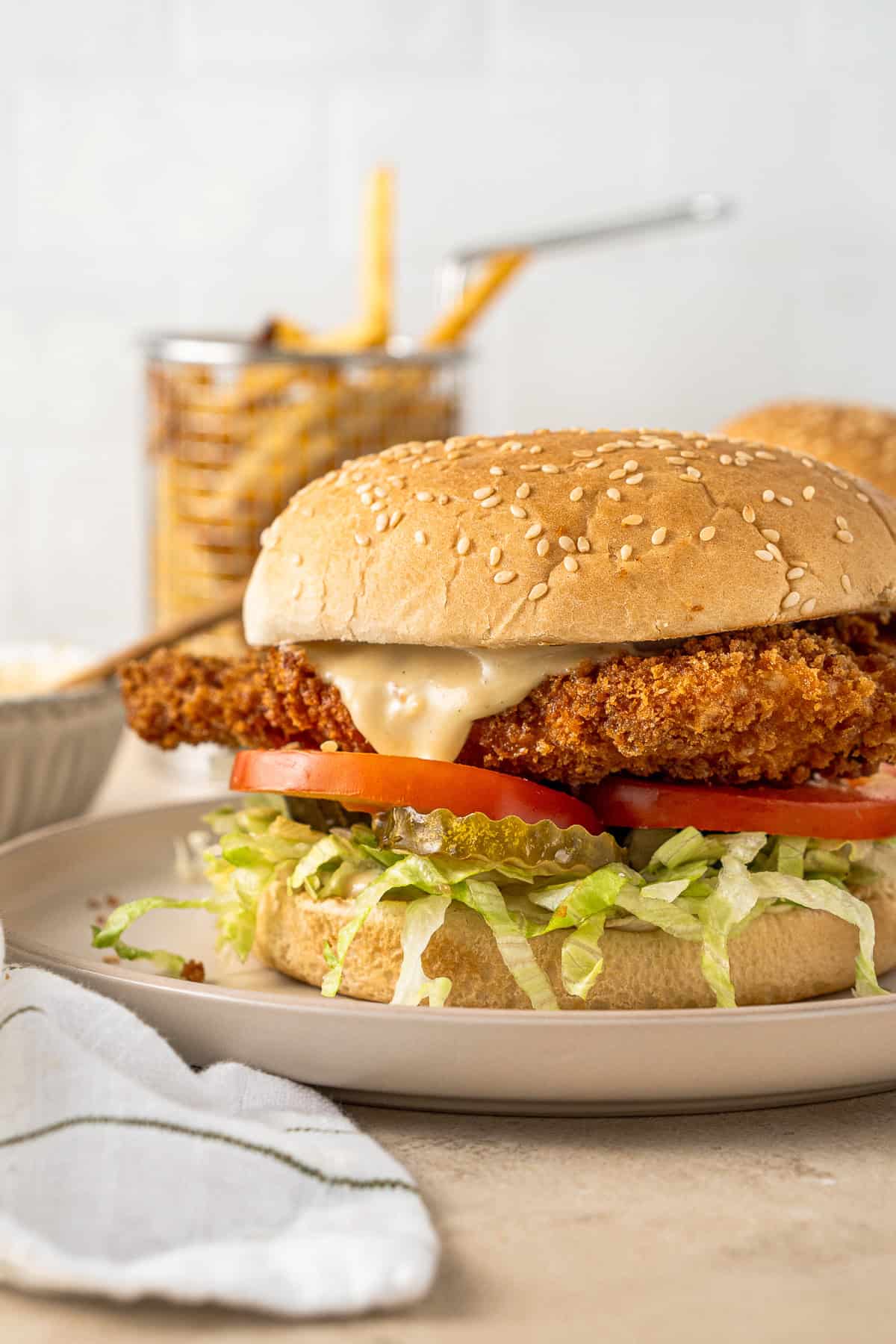 Close up of the chicken schnitzel burger with honey mustard sauce. 