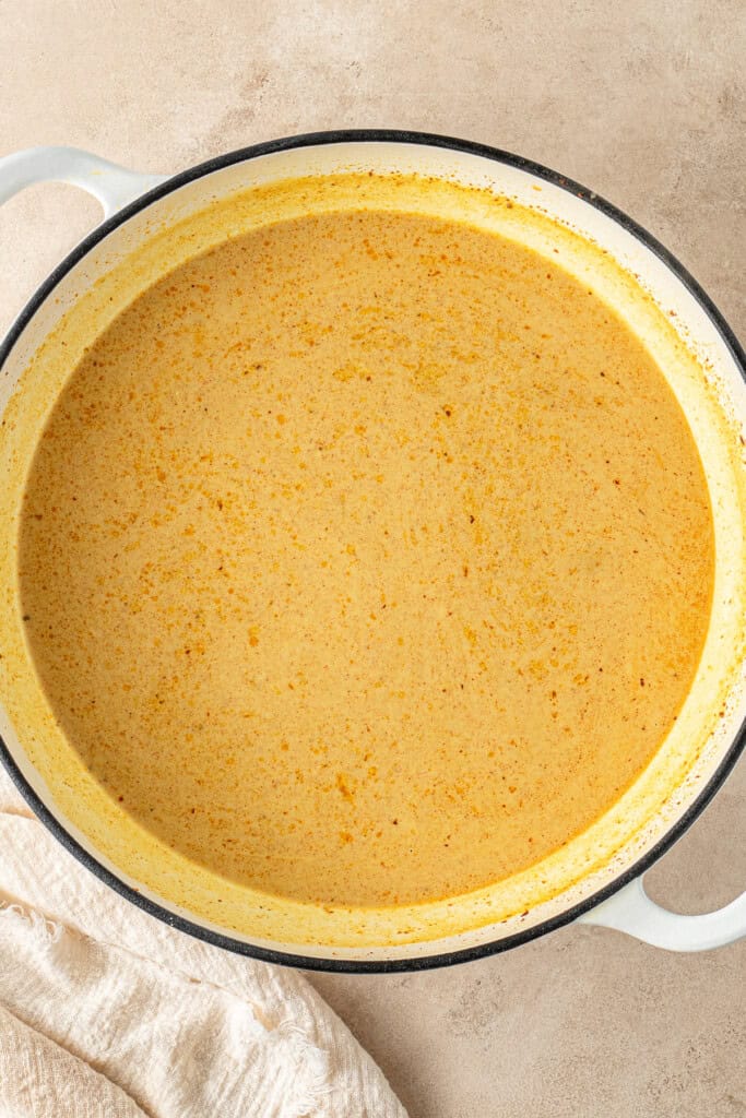 Adding the coconut milk to the pan.