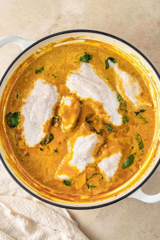 The cooked fish in the curry.