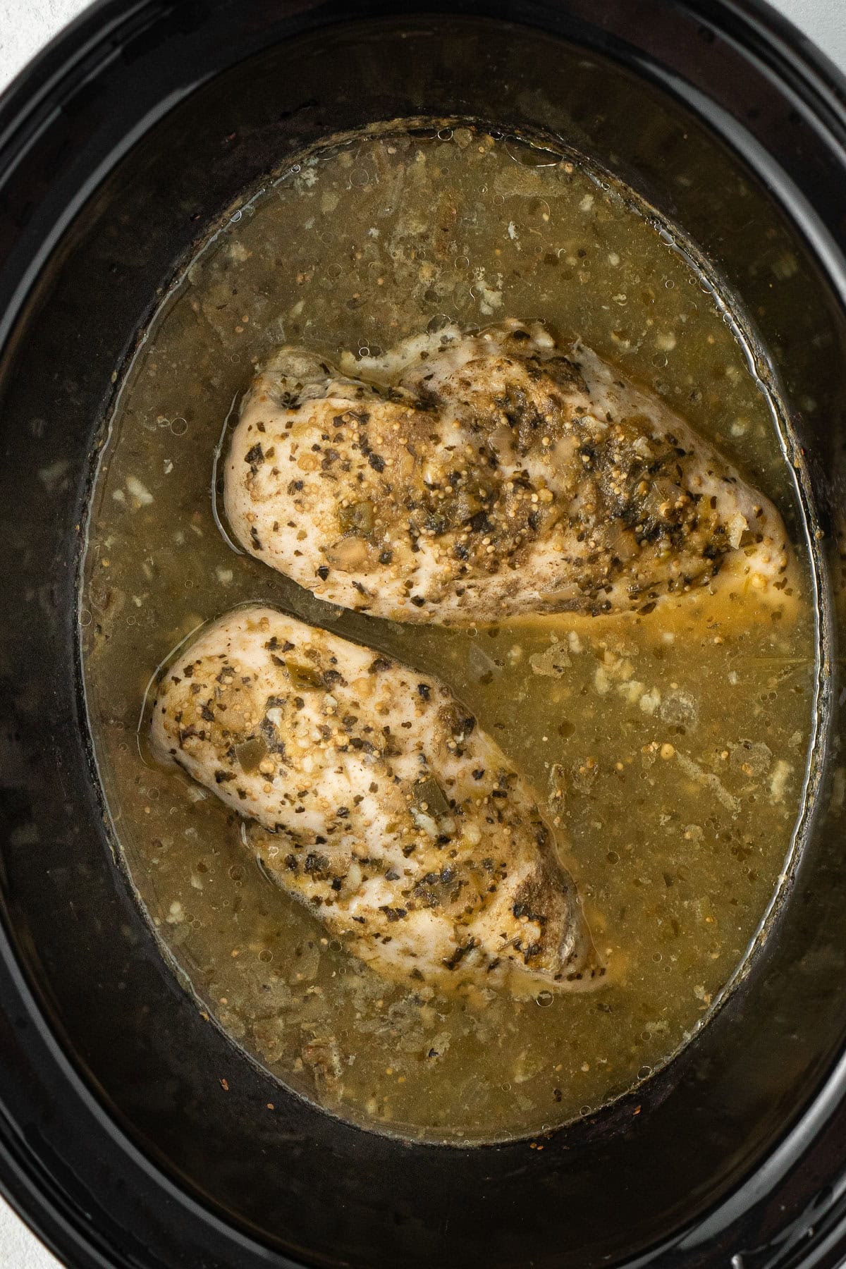 The cooked chicken in the slow cooker.