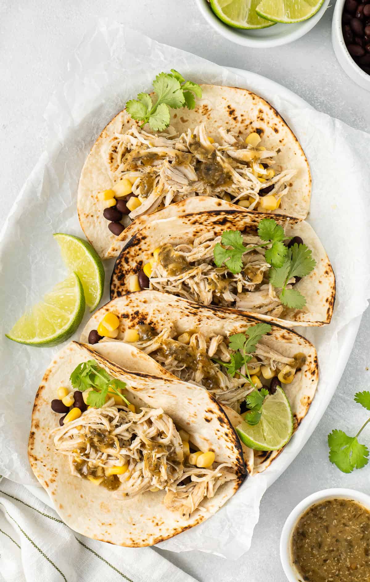 The salsa verde chicken served as tacos with lime and cilantro. 