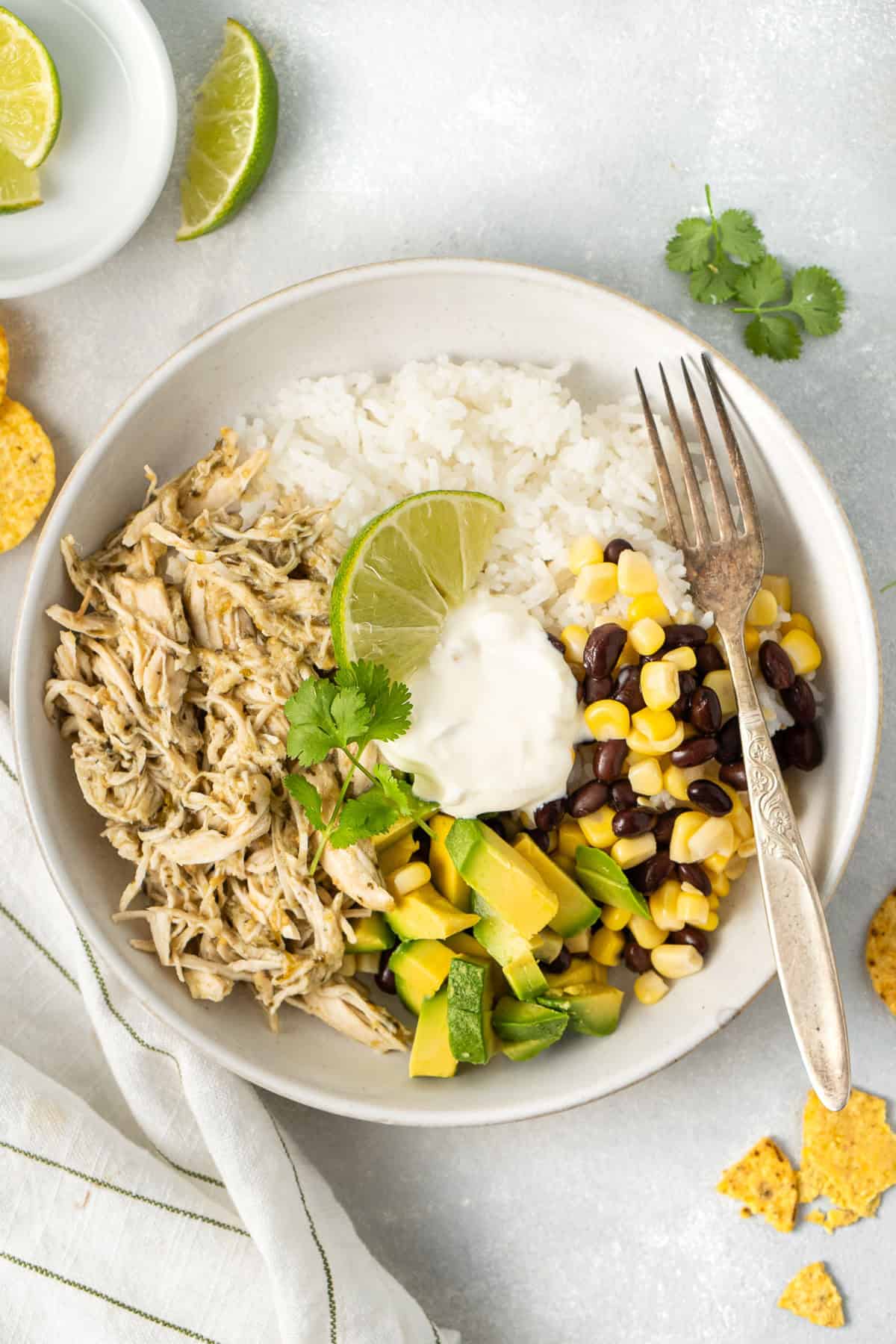The salsa verde chicken served in a rice bowl with avocado. 