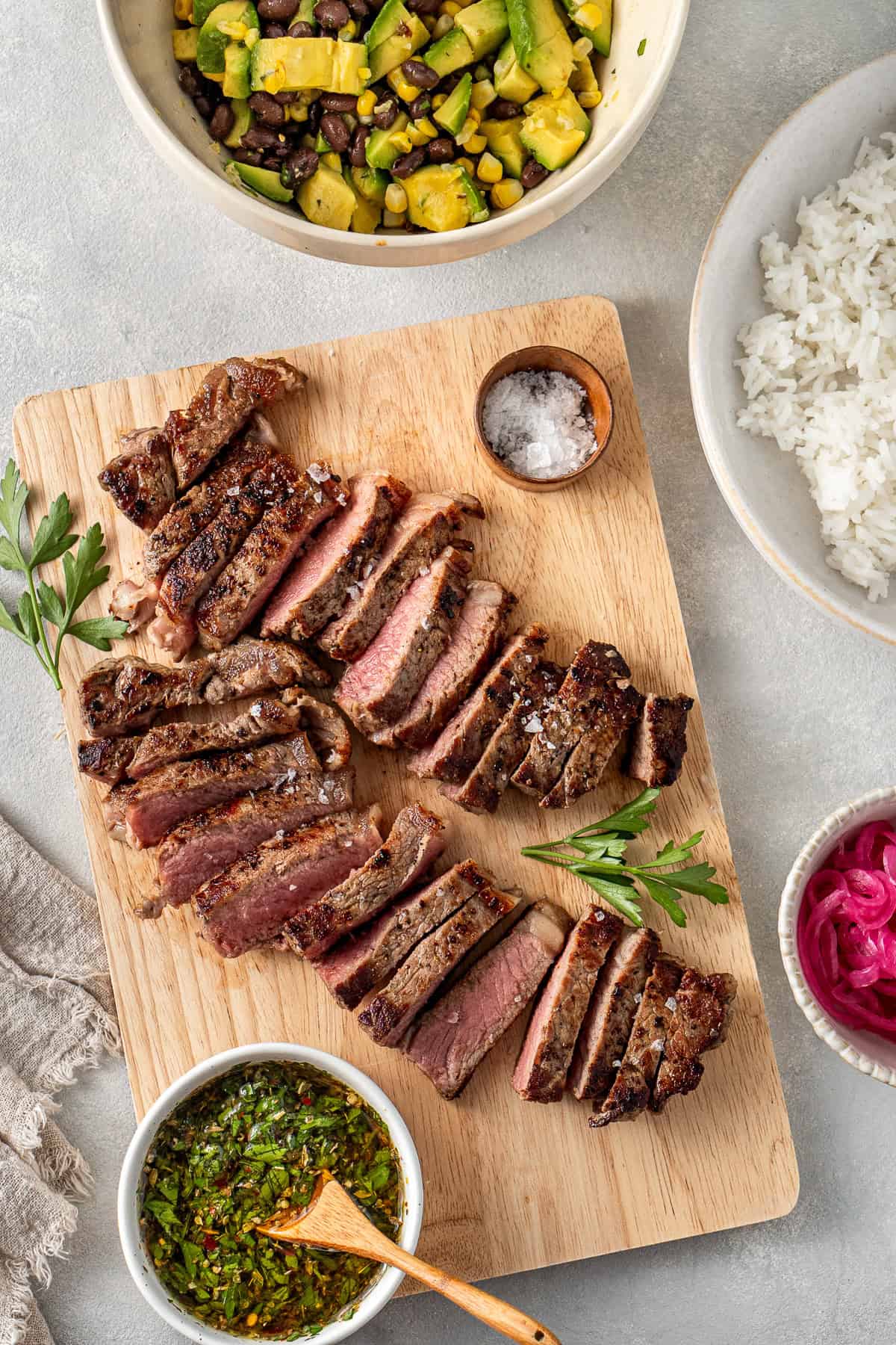 The sliced steak on a wooden board.