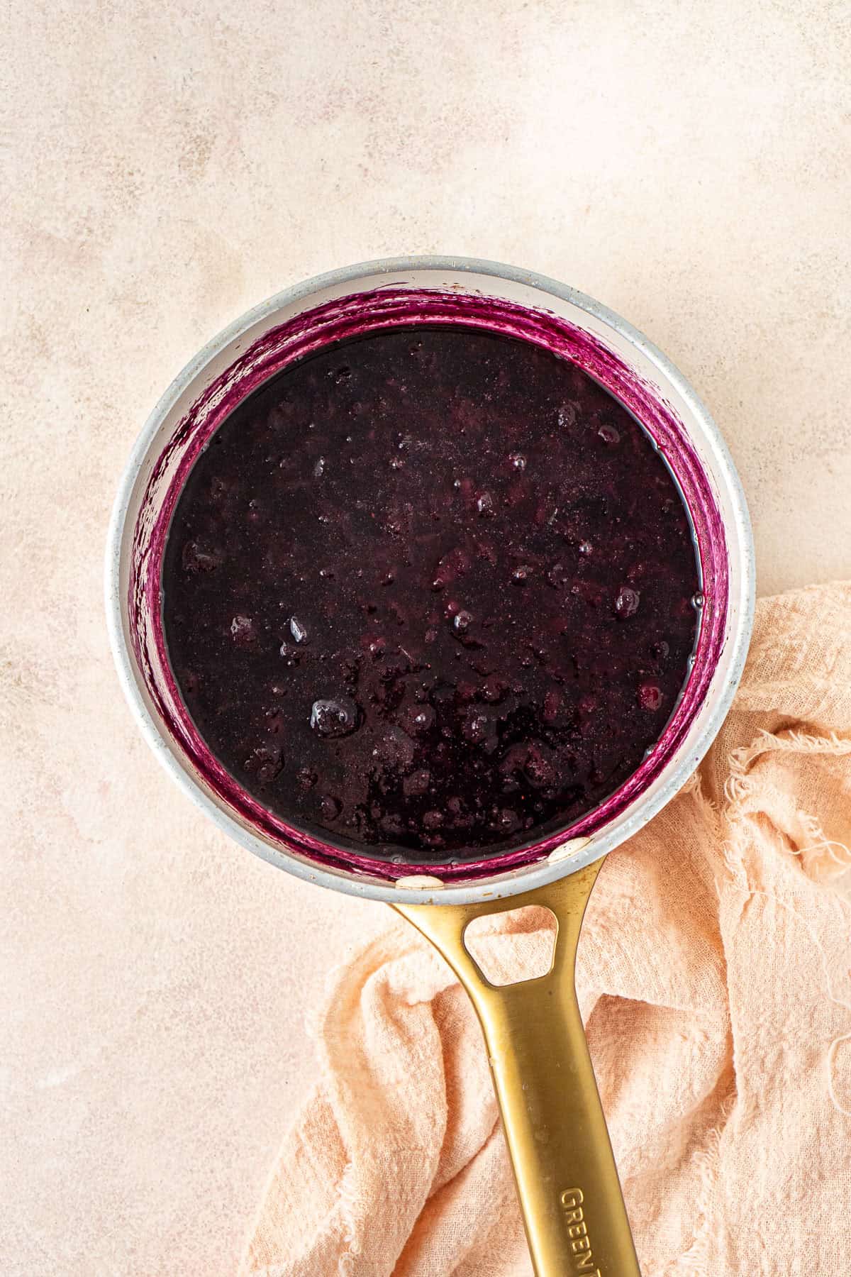 The blueberry syrup in a saucepan.