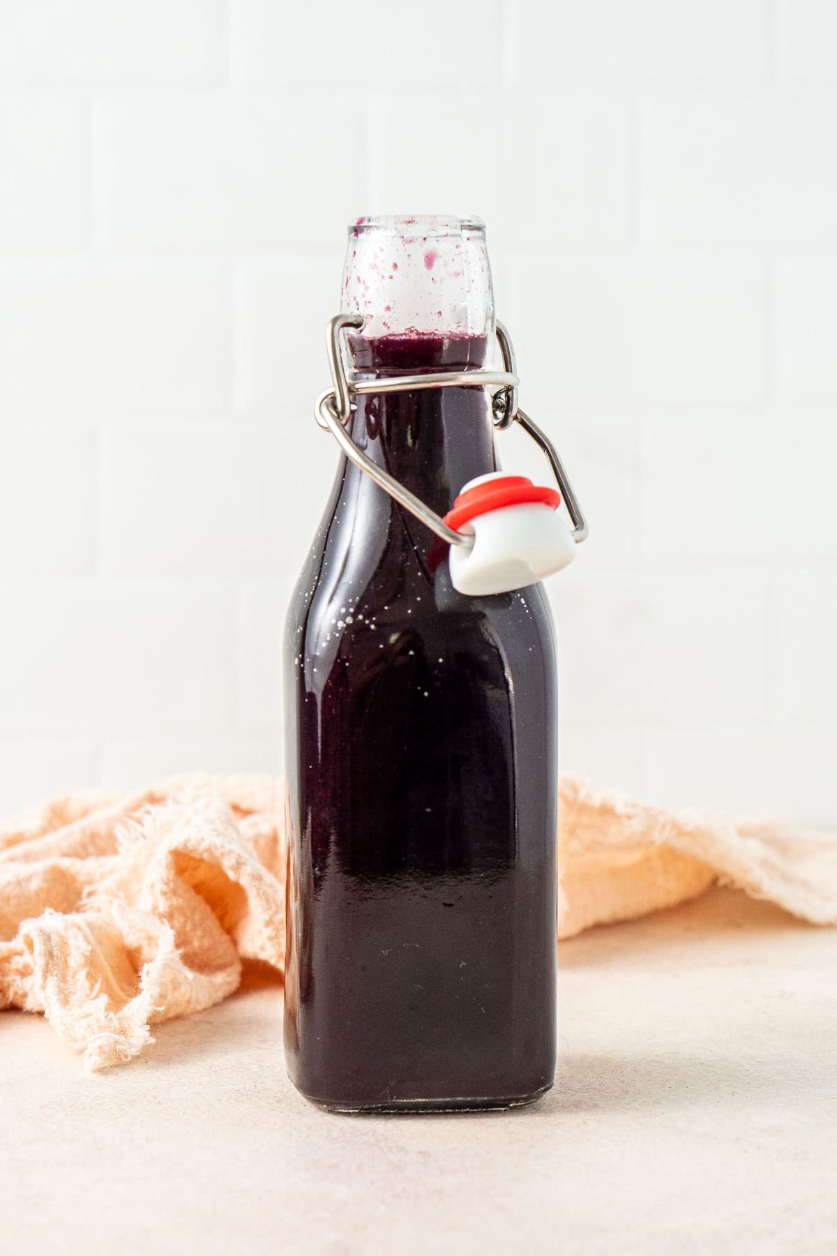 The blueberry syrup in a bottle.
