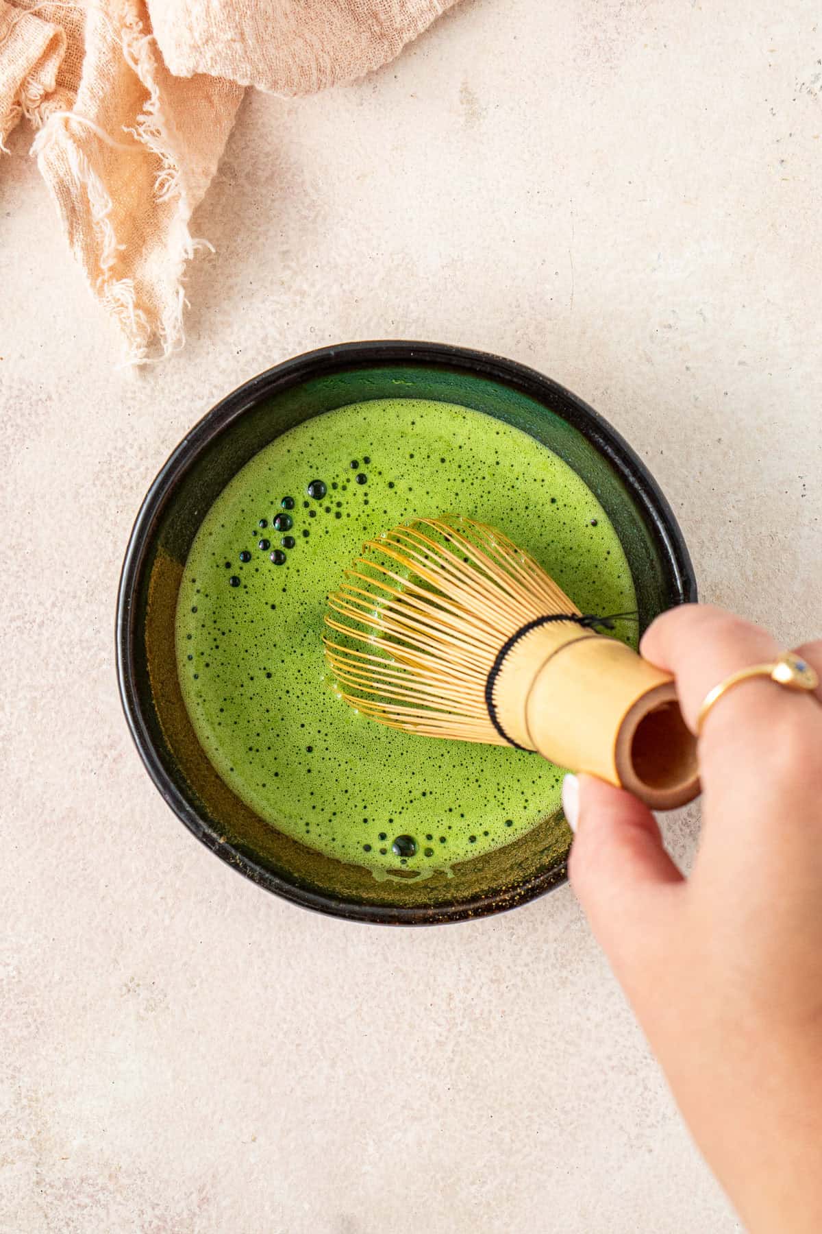 Whisking the matcha in a bowl.