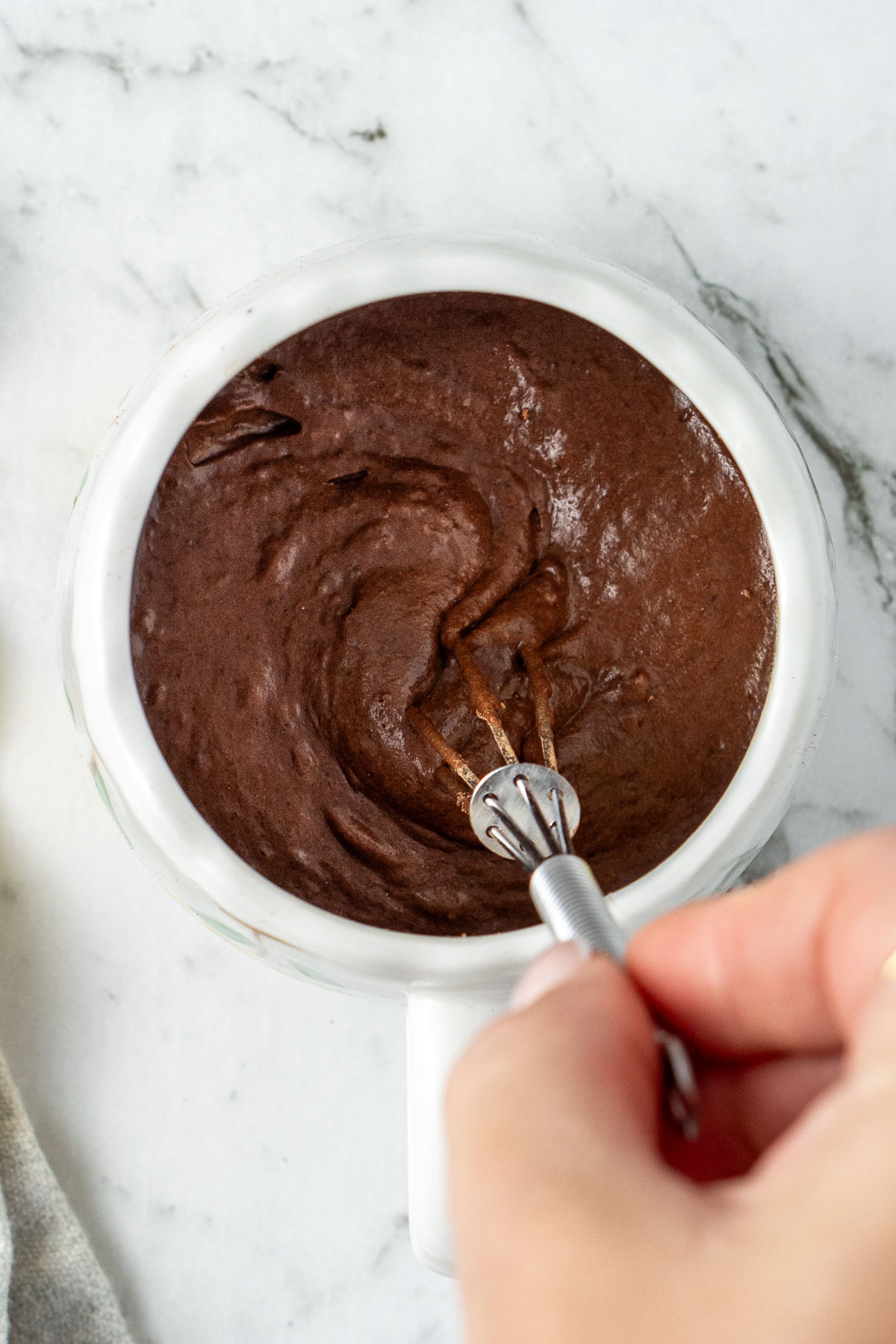 Mixing together the mug cake batter in the mug.