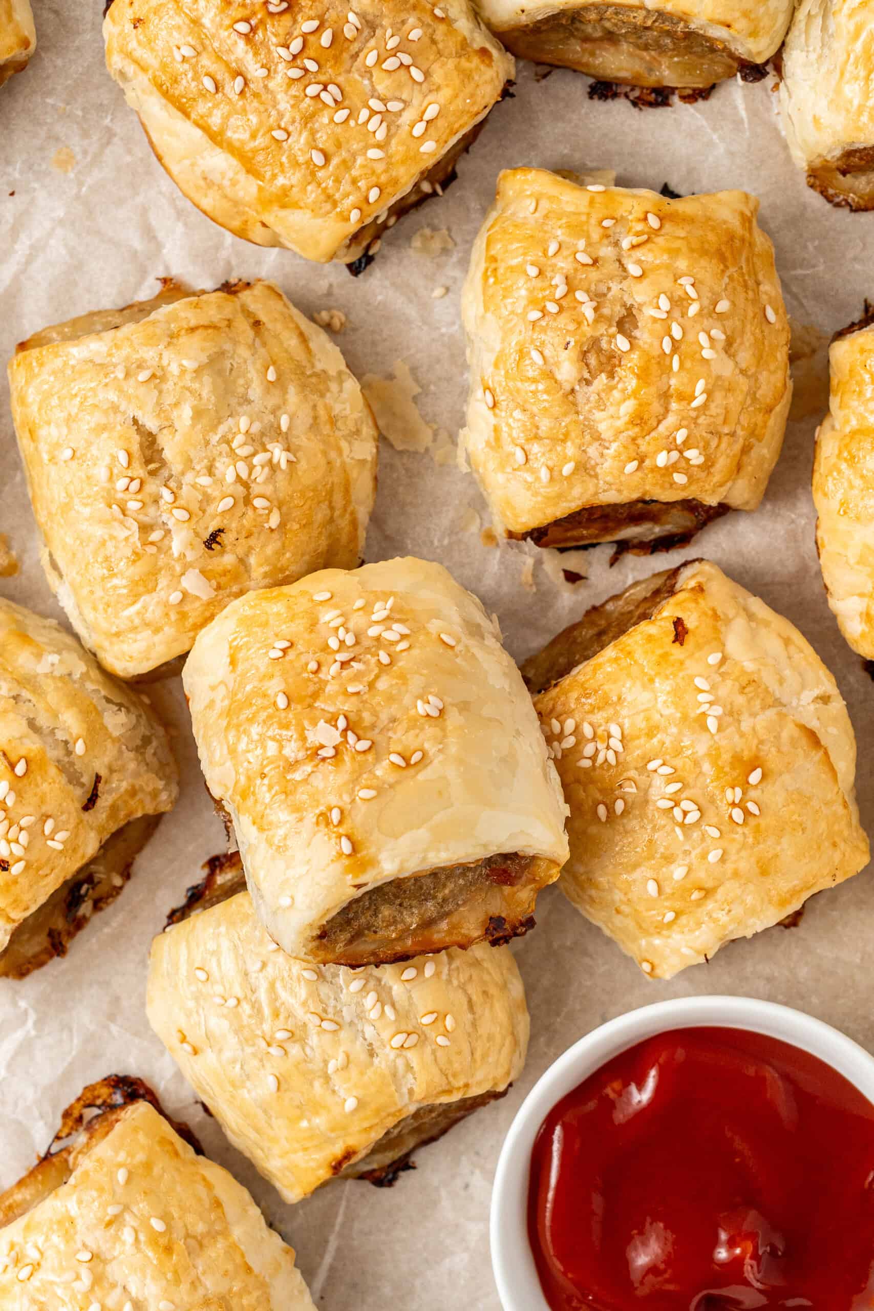 Baked pork and apple sausage rolls with tomato sauce. 