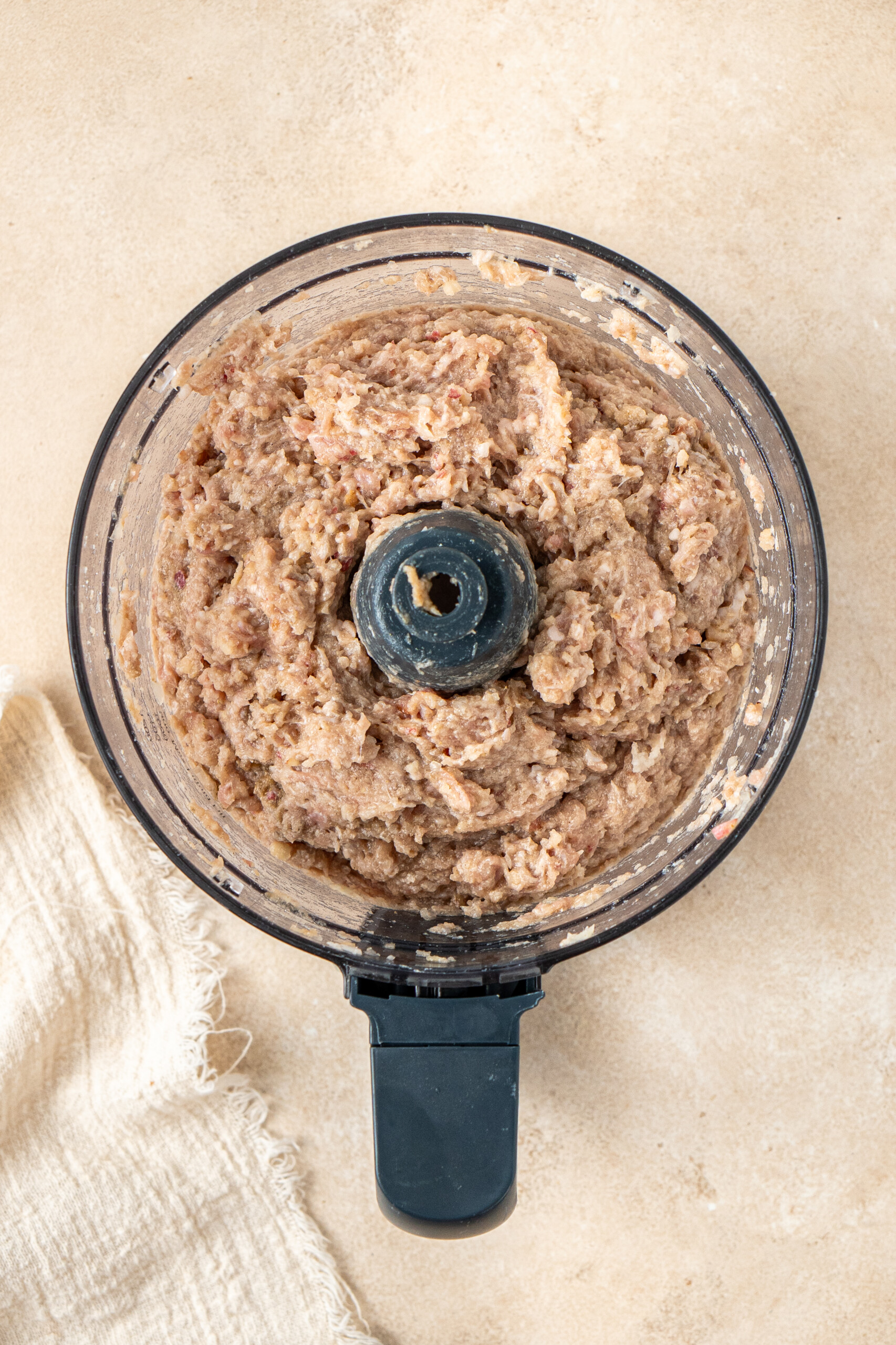 The pork and apple filling mixture in a food processor. 