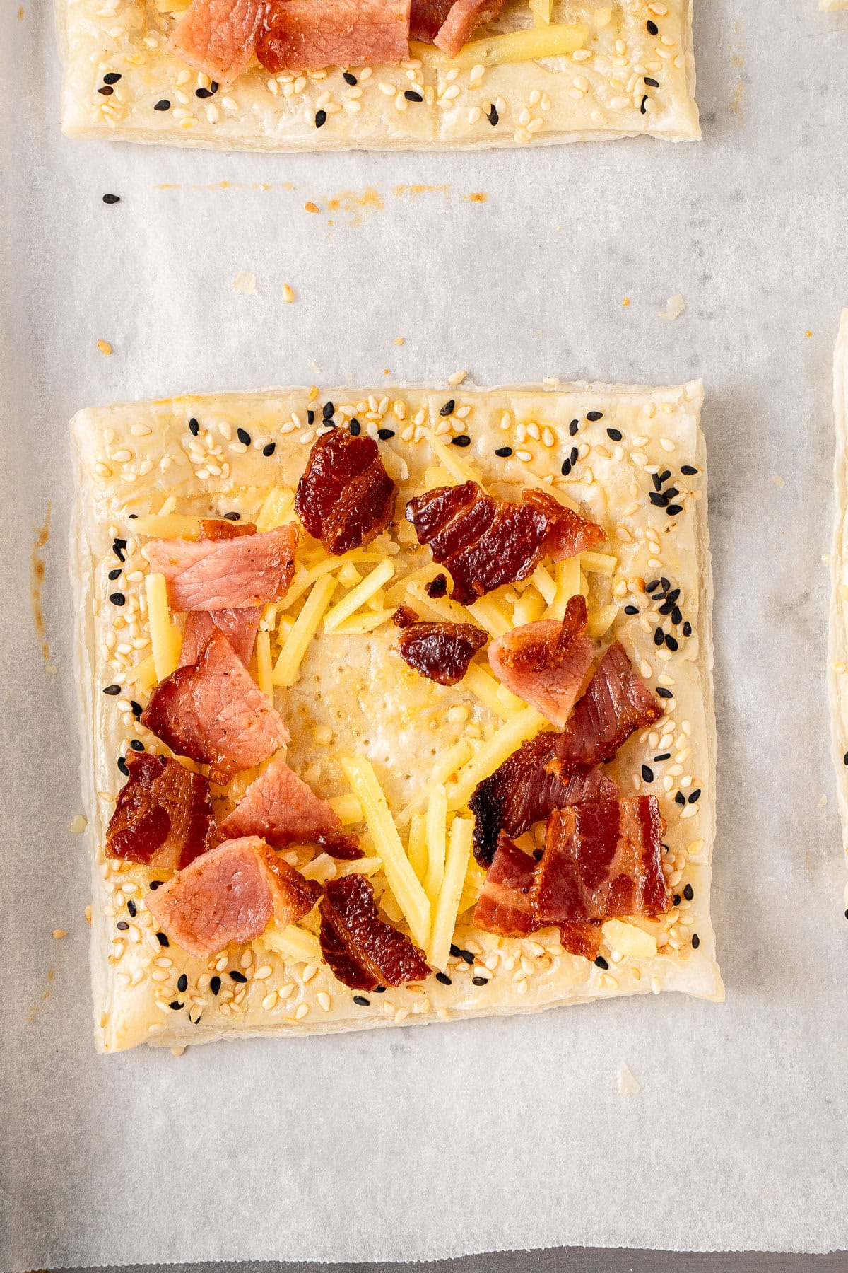 Arranging the dairy free cheese and bacon on the tart.