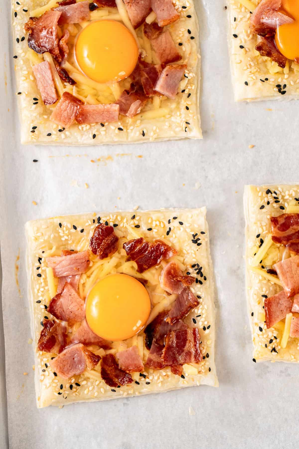 The raw egg cracked into the pastry tart.