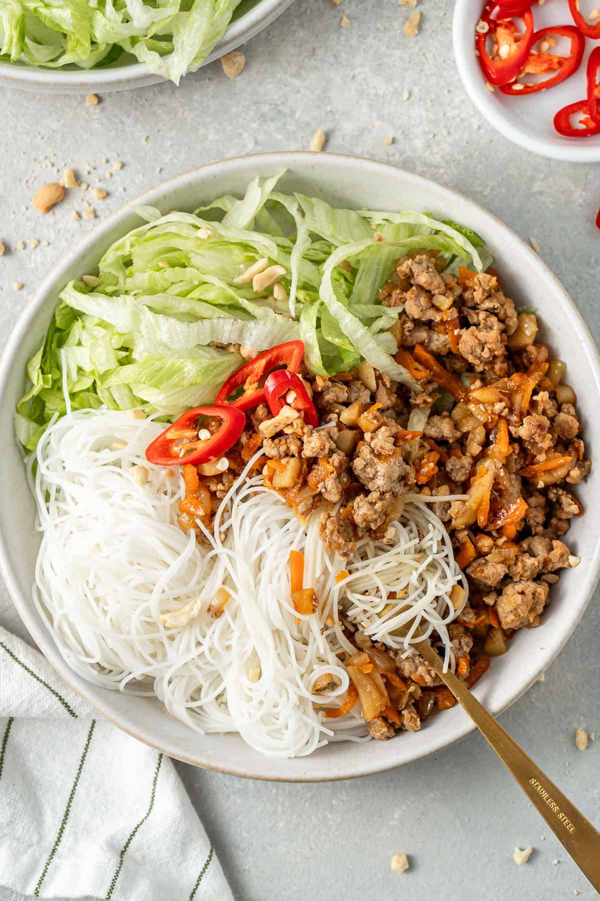 A fork tangled up in the noodles in a bowl.