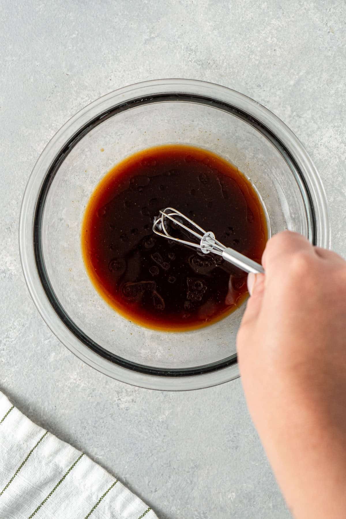 Mixing together the sauce ingredients in a small bowl.
