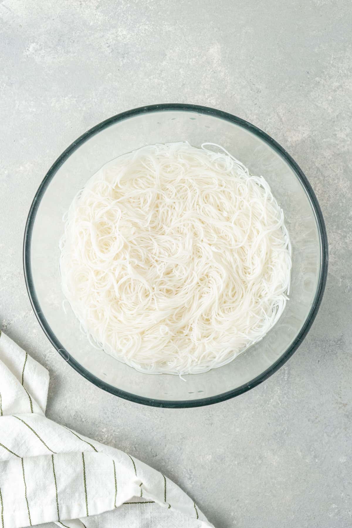 The rice noodles in a bowl of water.