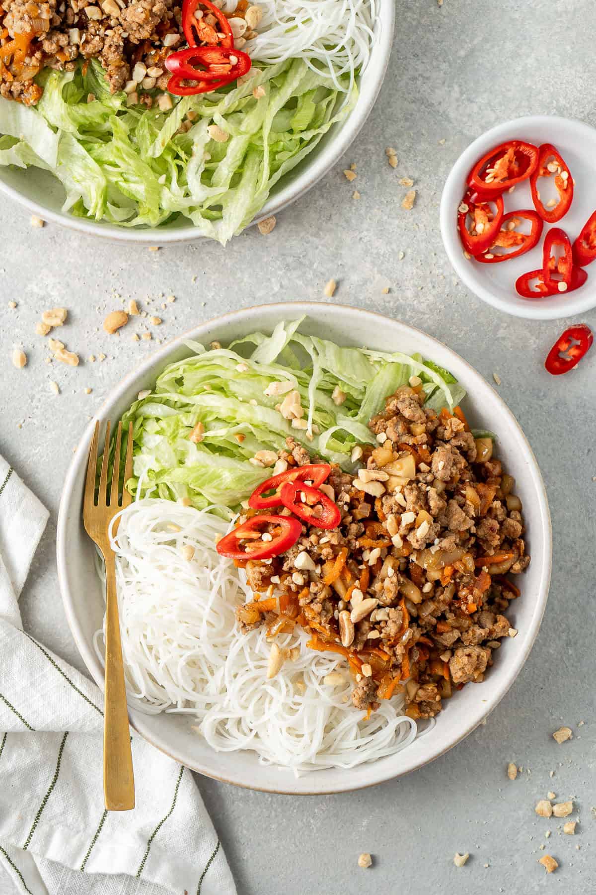 San choy bowl bowls with noodles, lettuce and fresh chilli.