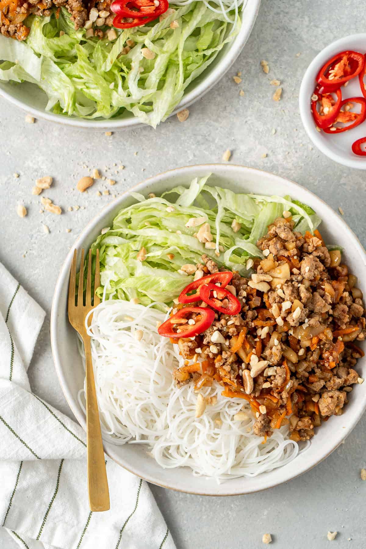 San choy bowl bowls with noodles and lettuce.