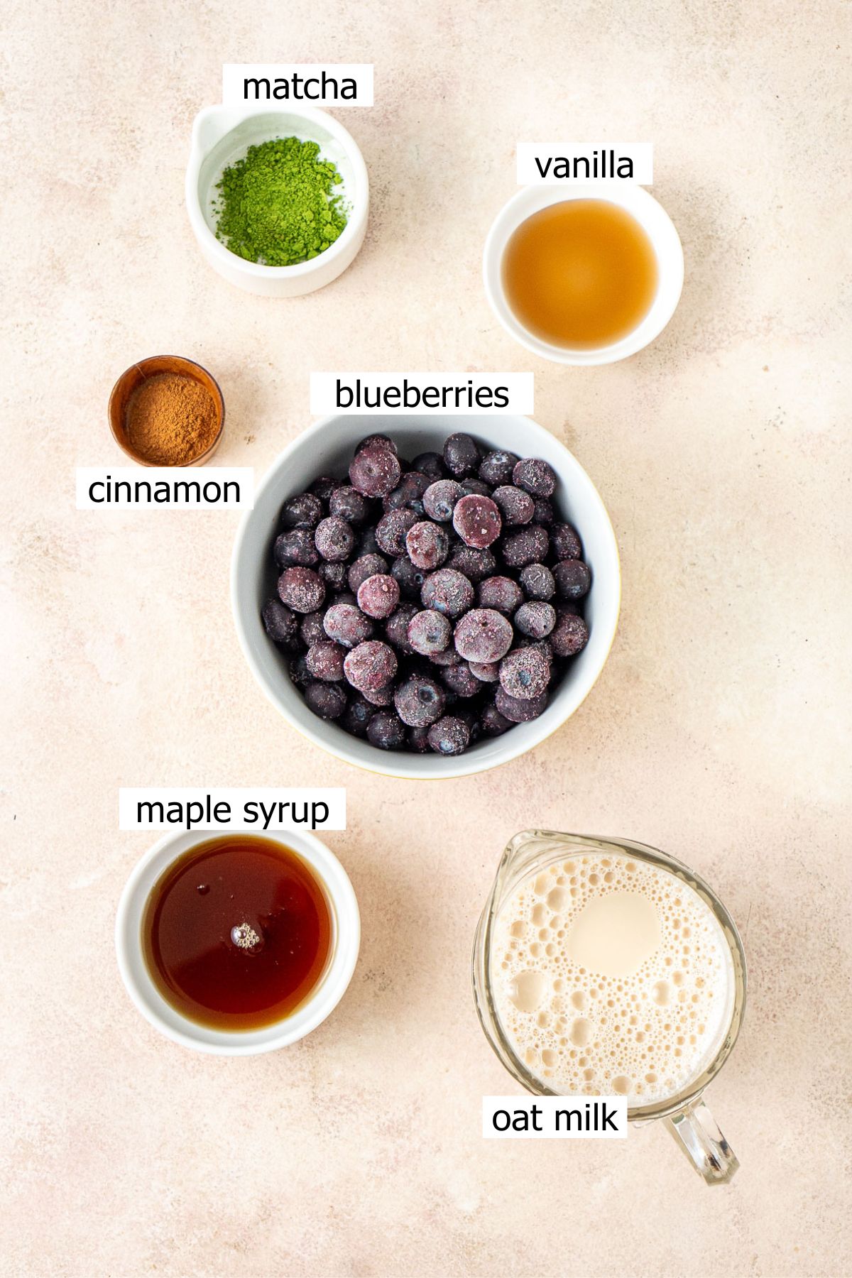All ingredients needed to make a blueberry matcha in small bowls.